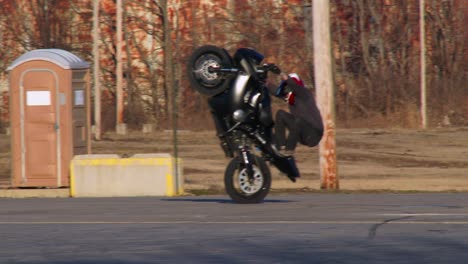 A-rider-performs-stunts-on-a-motorcycle-in-a-parking-lot-2