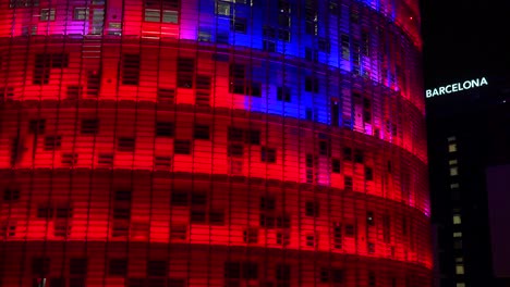 Remarkable-blue-and-red-skyscraper-at-night-in-Barcelona-Spain-2