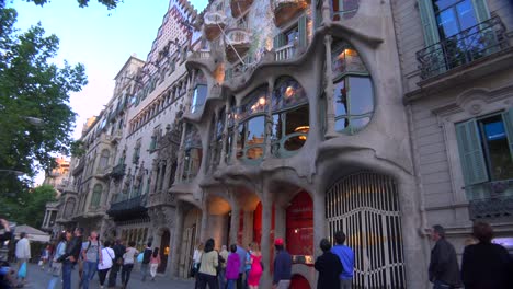 Pedestrians-walk-in-front-of-a-Gaudi-designed-building-in-Barcelona-Spain-1