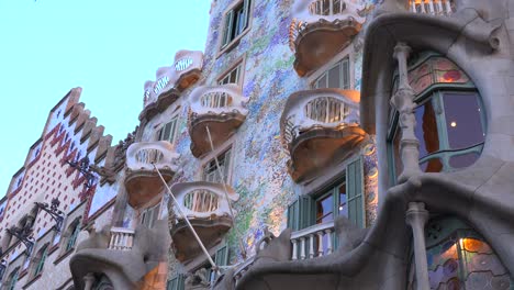 Pedestrians-walk-in-front-of-a-Gaudi-designed-building-in-Barcelona-Spain-2