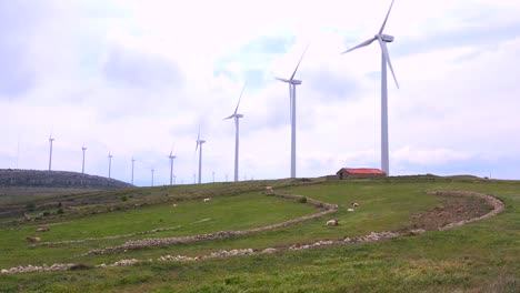 Wide-shot-of-windmills-generating-electricity-near-traditional-villages-in-Spain