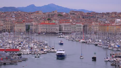 Boats-enter-and-exit-the-harbor-in-Marseilles-France