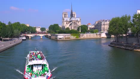 A-riverboat-travels-on-the-Seine-near-the-Notre-Dame-cathedral-in-Paris-1