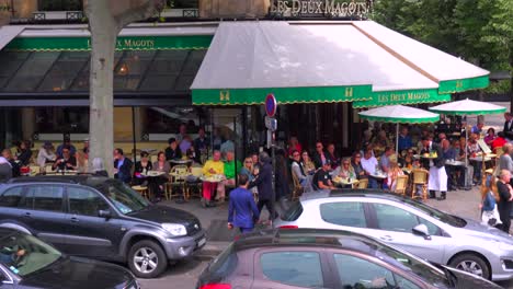 A-classic-Paris-outdoor-cafe-with-many-patrons-and-waiters-serving