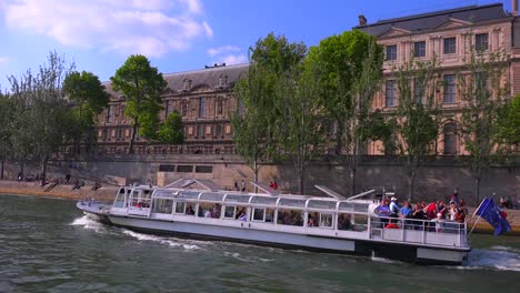 A-point-of-view-of-a-bateaux-mouche-riverboat-traveling-along-the-Seine-River-in-Paris