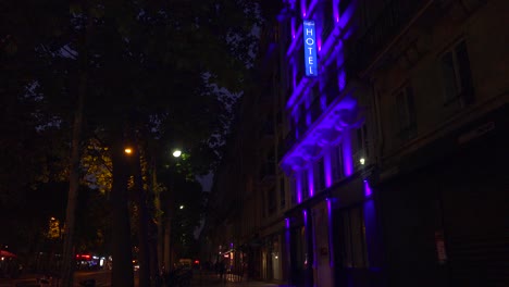 A-neon-sign-identifies-a-European-hotel-at-night