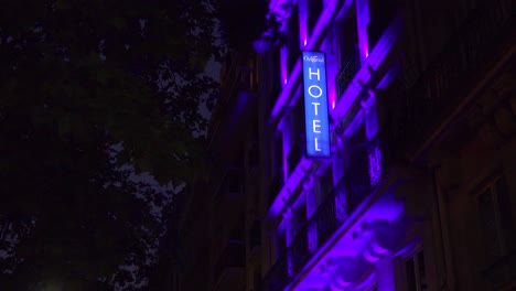 A-neon-sign-identifies-a-European-hotel-at-night-1