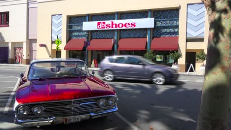 Exterior-establishing-shot-of-a-shoe-store-with-a-classic-car-foreground