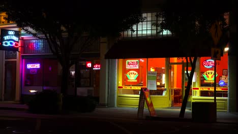 Establishing-shot-of-a-small-retail-storefront-business-district-at-night-1