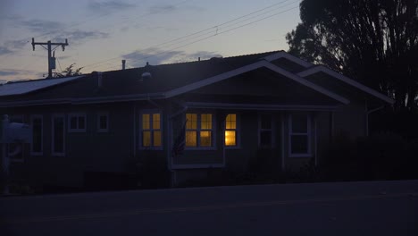 A-1940's-style-house-with-the-lights-on-at-night