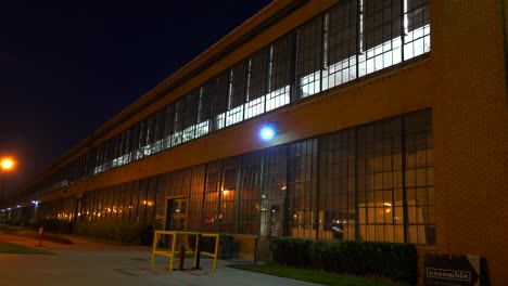 An-establishing-shot-of-a-warehouse-or-factory-at-night