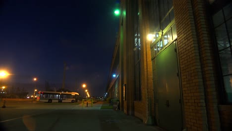 Lights-glow-inside-a-warehouse-or-factory-at-night-1