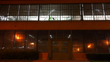 Lights-glow-inside-a-warehouse-or-factory-at-night-2