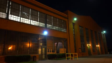 Lights-glow-inside-a-warehouse-or-factory-at-night-3