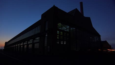Wide-shot-of-a-large-warehouse-or-factory-at-dusk-or-sunset-4