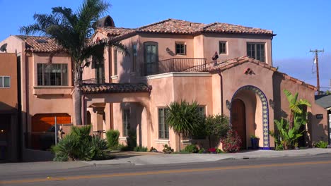Establishing-shot-of-a-large-Spanish-style-home-on-a-modern-street