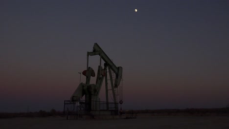 An-oil-derrick-pumps-against-the-night-sky