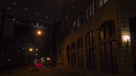 Establishing-shot-of-warehouses-under-the-Brooklyn-Bridge-with-subway-train-crossing
