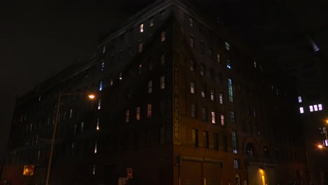 Wide-shot-of-a-New-York-or-Brooklyn-apartment-complex-in-a-warehouse-district-at-night