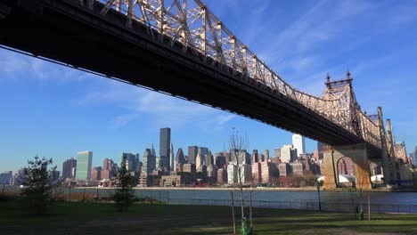 Low-angle-view-of-the-Queensboro-Bridge-with-the-New-York-skyline-background