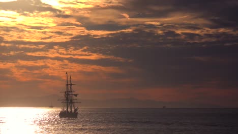 A-tall-clipper-ship-sails-at-sunset-1