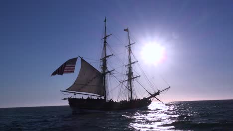 A-tall-masted-clipper-ship-sails-on-the-high-seas-with-an-american-flag-flying-2