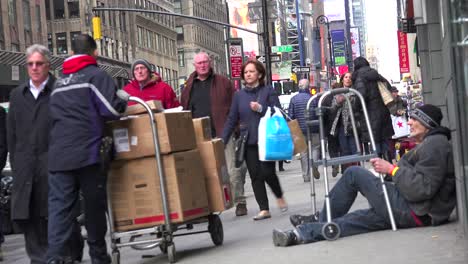 Huge-crowds-of-people-pass-a-homeless-person-on-the-streets-of-Manhattan-New-York-City-without-noticing--1