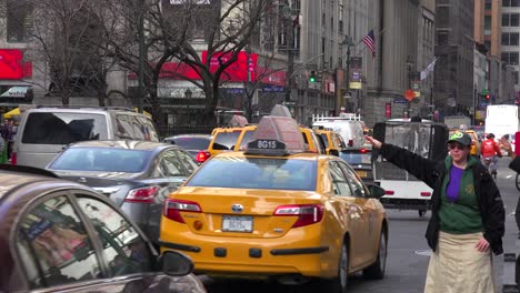A-woman-hails-a-New-York-taxi-in-the-rain