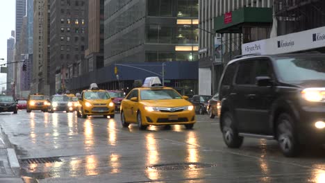 Cars-pass-on-wet-streets-in-midtown-Manhattan-New-York-city