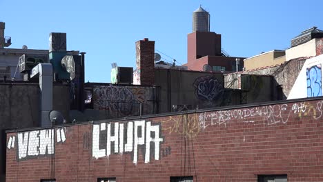 Graffitti-art-appears-on-the-side-of-a-building-against-the-skyline-in-New-York-City