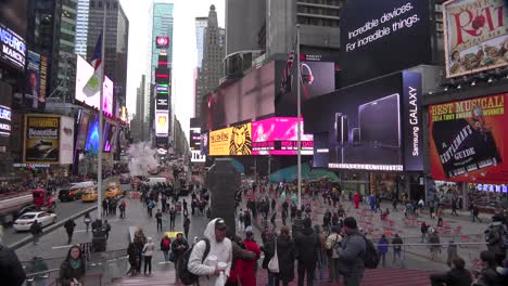 Pan-across-crowds-of-people-and-bright-neon-advertisements-in-Times-Square-New-York-City