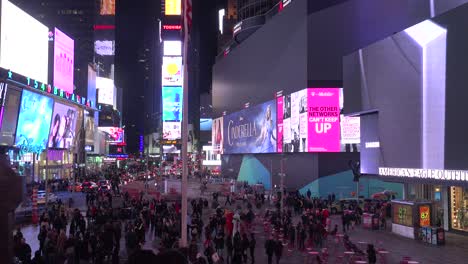 Pan-across-crowds-of-people-and-bright-neon-advertisements-in-Times-Square-New-York-City-1