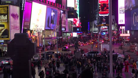 Nighttime-crowds-of-people-and-bright-neon-advertisements-in-Times-Square-New-York-City