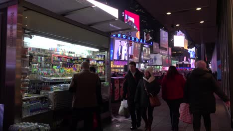 Nighttime-crowds-of-people-and-bright-neon-advertisements-in-Times-Square-New-York-City-1