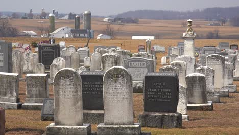 An-establishing-shot-of-an-Amish-graveyard-in-Pennsylvania-with-a-farm-distant