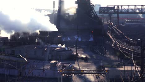 Establishing-shot-of-a-busy-steel-mill-with-smoke-belching-suggests-global-warming-2