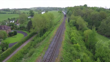 An-aerial-over-the-Orient-Express-steam-train-passing-through-the-English-countryside