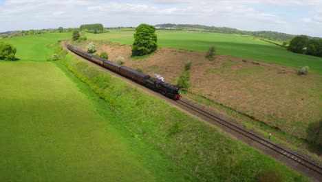 An-aerial-of-a-steam-train-as-it-passes-through-the-English-countryside-at-high-speed