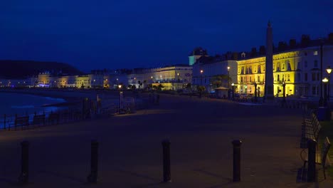 Elegant-hotels-line-a-beachfront-at-night-in-England