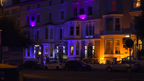 Victorian-houses-pubs-and-hotels-are-lit-at-night-in-an-English-town-