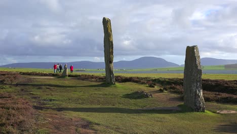 People-walk-near-the-sacred-Celtic-stones-on-the-Islands-of-Orkney-in-Northern-Scotland