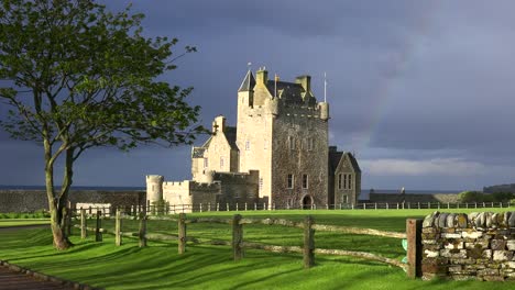Establishing-shot-of-a-beautiful-Scottish-or-English-castle-estate-in-sunset-light-with-rainbow-background