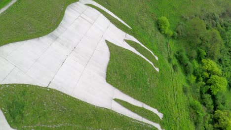 Aerial-over-a-giant-white-horse-with-farm-fields-foreground-in-Westbury-England-1