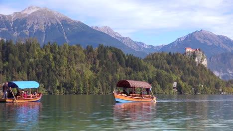 A-rowboat-passes-the-fort-on-Lake-Bled-Slovenia-1