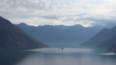 Sunlight-penetrates-the-clouds-and-illuminates-the-Our-Lady-rock-island-church-in-Boka-Bay-Montenegro-2