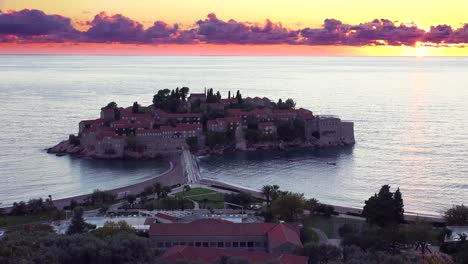 Remarkable-high-angle-sunset-shot-over-the-beautiful-Sveti-Stefan-island-in-Montenegro