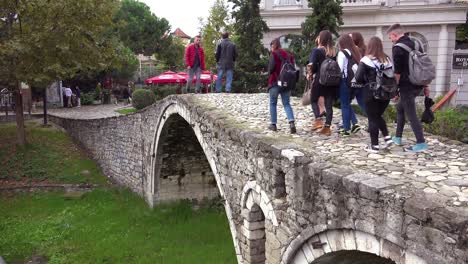Pedestrians-walk-over-an-old-stone-bridge-in-Tirana-Albania