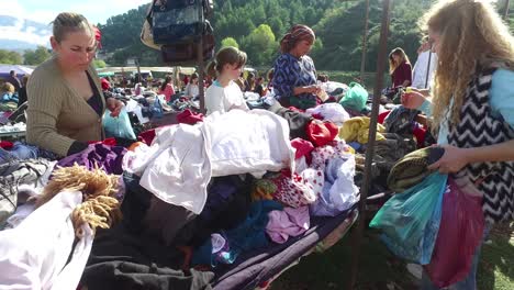 Moving-POV-shot-through-a-large-outdoor-gypsy-flea-market-in-the-Alps-of-Albania-3