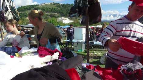 Moving-POV-shot-through-a-large-outdoor-gypsy-flea-market-in-the-Alps-of-Albania-4