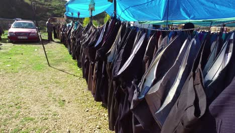 Long-line-of-clothing-in-a-large-outdoor-gypsy-flea-market-in-the-Alps-of-Albania